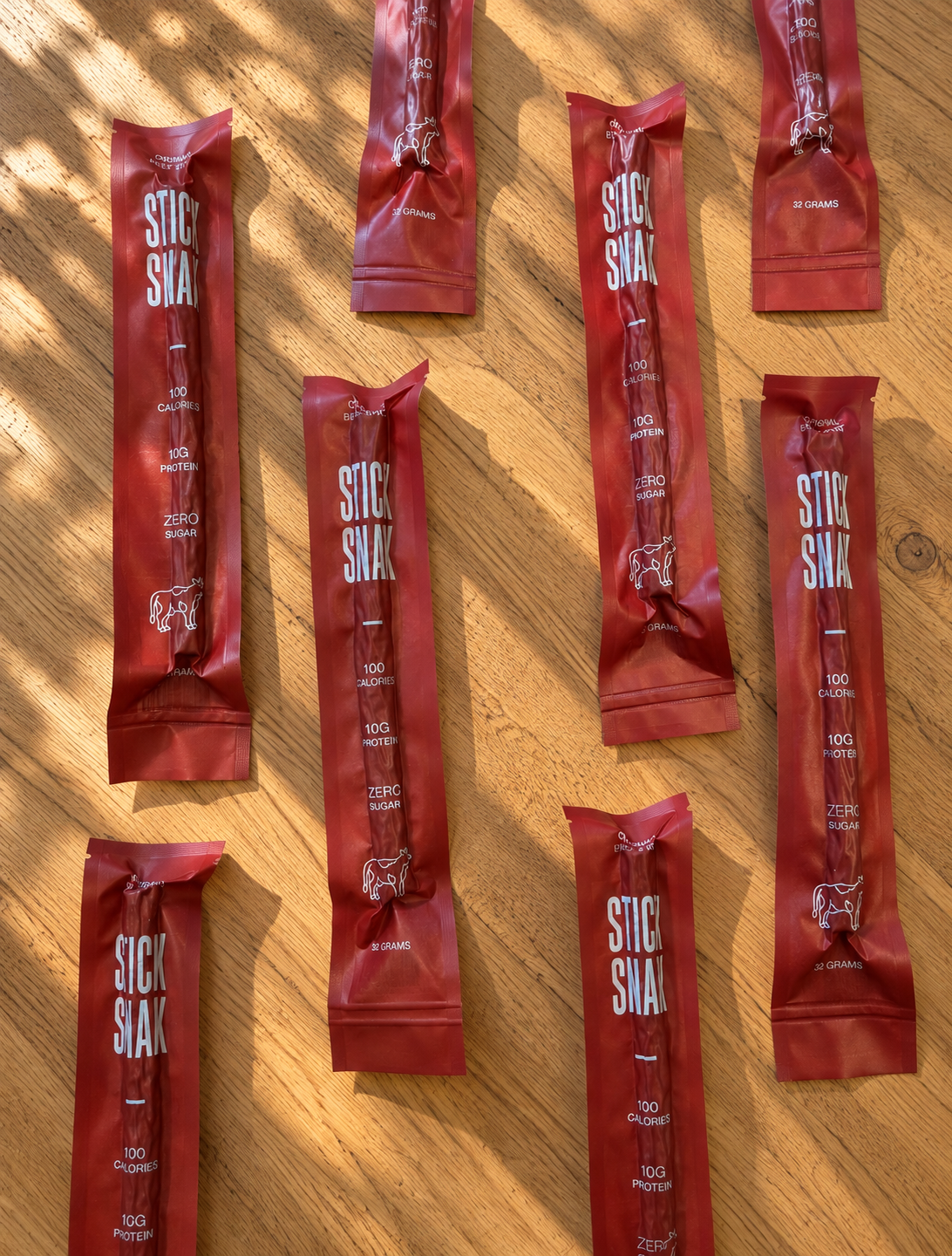 Stick Snak beef sticks displayed on a wooden table